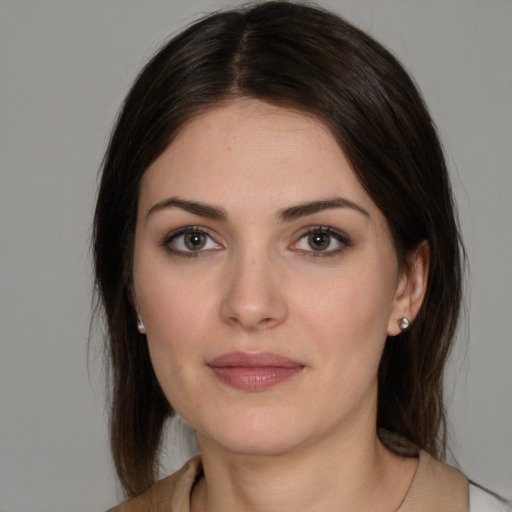 Joyful white young-adult female with medium  brown hair and brown eyes