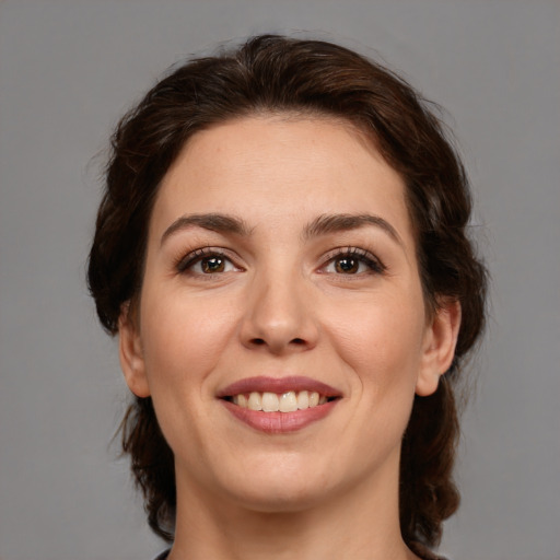 Joyful white young-adult female with medium  brown hair and brown eyes