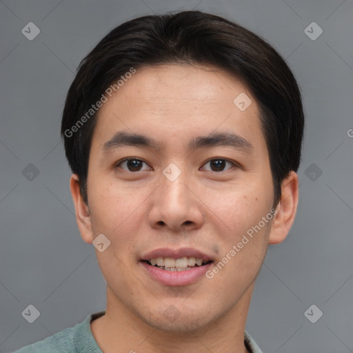 Joyful asian young-adult male with short  brown hair and brown eyes