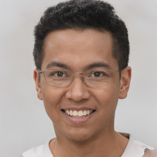 Joyful latino young-adult male with short  brown hair and brown eyes