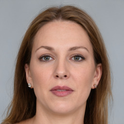 Joyful white adult female with long  brown hair and grey eyes