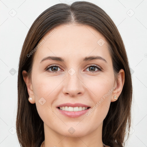 Joyful white young-adult female with long  brown hair and brown eyes