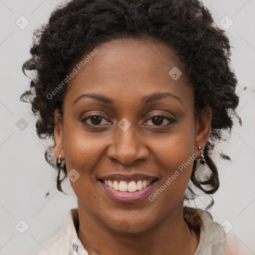 Joyful black adult female with medium  brown hair and brown eyes