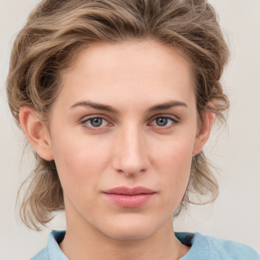 Joyful white young-adult female with medium  brown hair and blue eyes