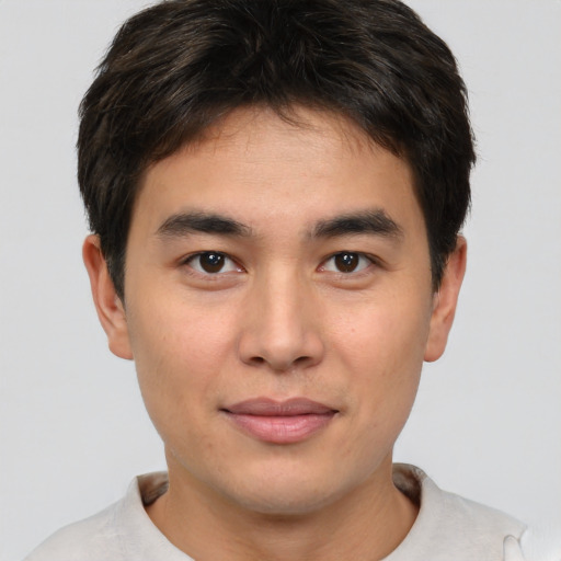 Joyful asian young-adult male with short  brown hair and brown eyes