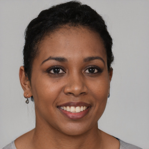 Joyful latino young-adult female with short  brown hair and brown eyes