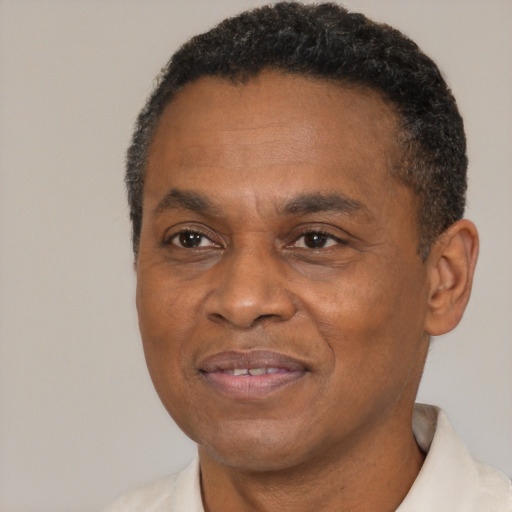 Joyful black adult male with short  brown hair and brown eyes