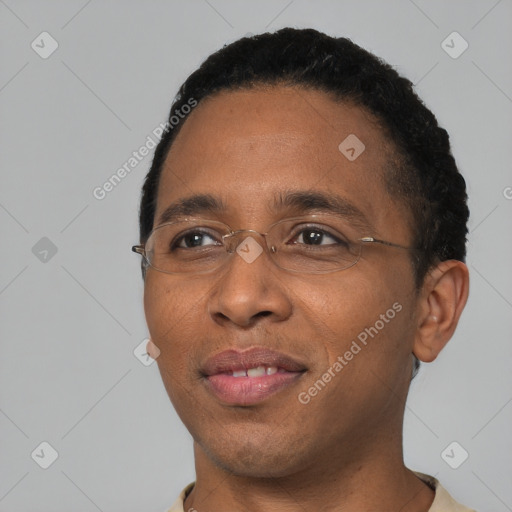 Joyful black young-adult male with short  black hair and brown eyes