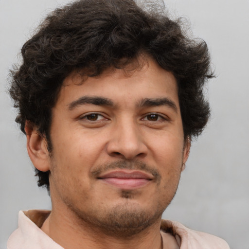 Joyful latino young-adult male with short  brown hair and brown eyes