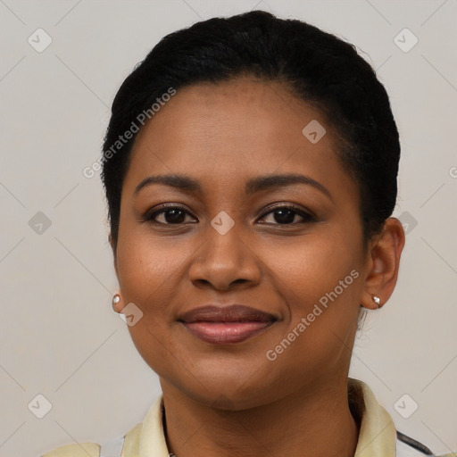 Joyful black young-adult female with short  black hair and brown eyes