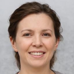 Joyful white adult female with medium  brown hair and brown eyes