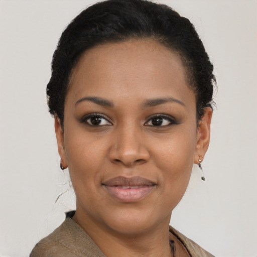 Joyful black young-adult female with short  black hair and brown eyes