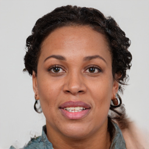 Joyful black adult female with short  brown hair and brown eyes