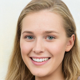 Joyful white young-adult female with long  brown hair and blue eyes