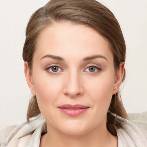 Joyful white young-adult female with long  brown hair and blue eyes