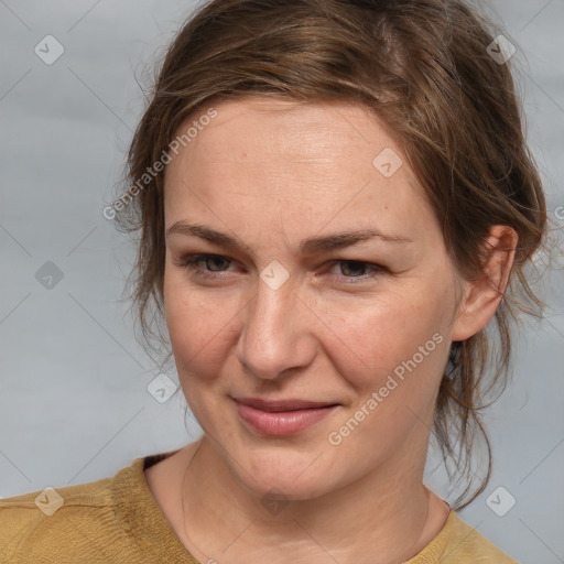 Joyful white adult female with medium  brown hair and brown eyes