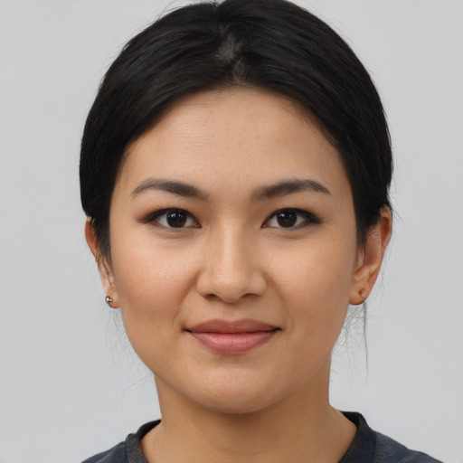 Joyful latino young-adult female with medium  black hair and brown eyes