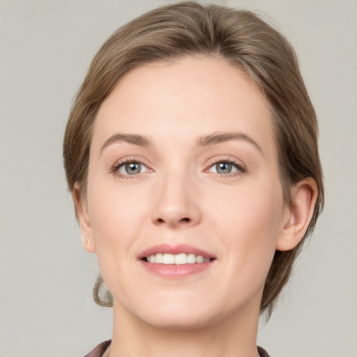 Joyful white young-adult female with short  brown hair and grey eyes