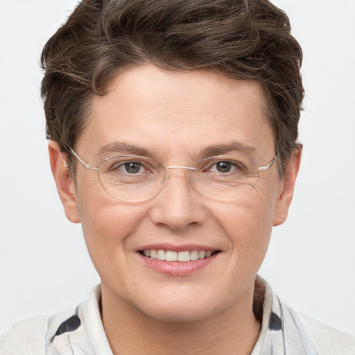 Joyful white adult male with short  brown hair and grey eyes