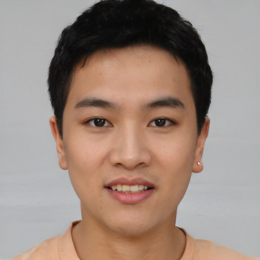 Joyful asian young-adult male with short  black hair and brown eyes
