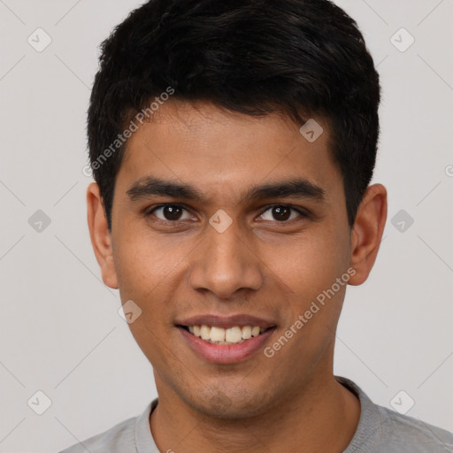 Joyful white young-adult male with short  black hair and brown eyes