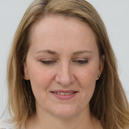 Joyful white adult female with long  brown hair and brown eyes