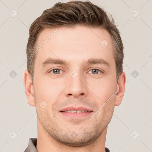 Joyful white young-adult male with short  brown hair and grey eyes