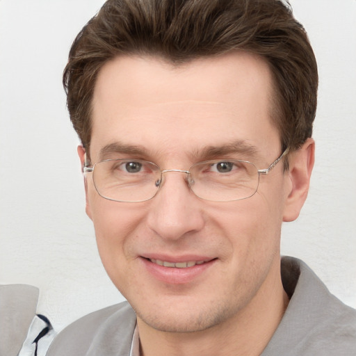 Joyful white adult male with short  brown hair and grey eyes