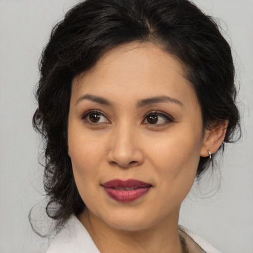 Joyful asian young-adult female with medium  brown hair and brown eyes