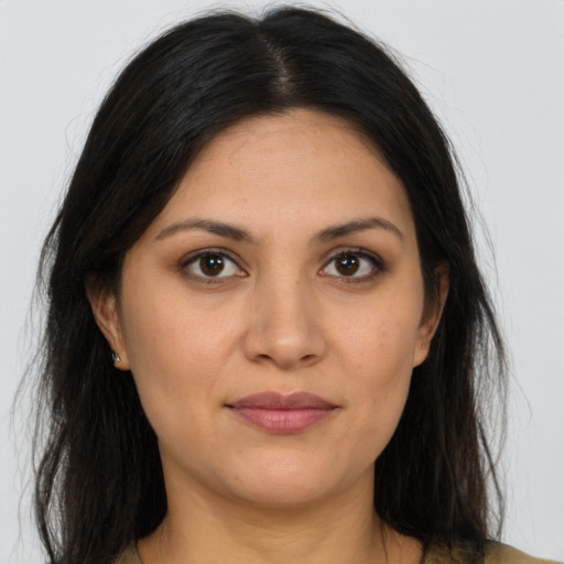 Joyful latino young-adult female with long  brown hair and brown eyes