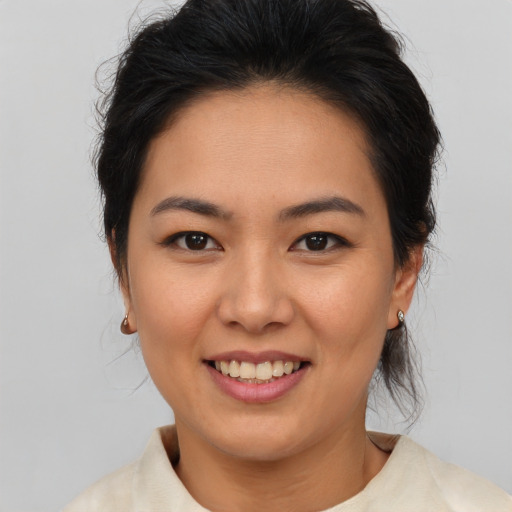 Joyful asian young-adult female with medium  brown hair and brown eyes