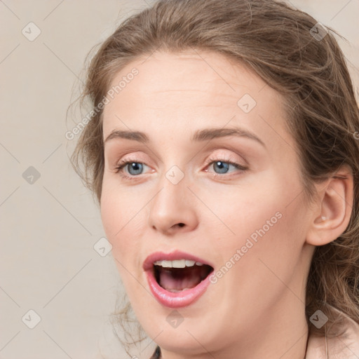 Joyful white young-adult female with medium  brown hair and green eyes