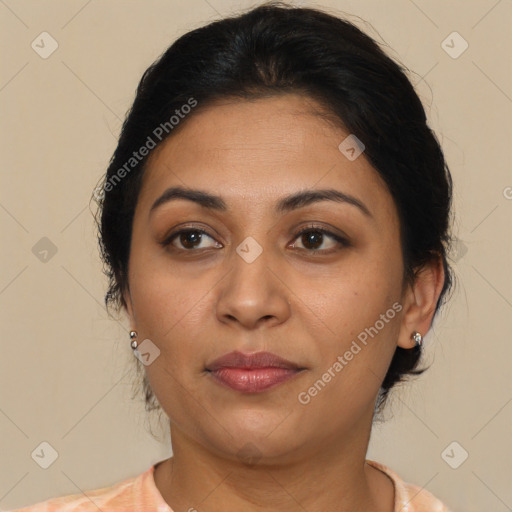 Joyful latino young-adult female with medium  brown hair and brown eyes