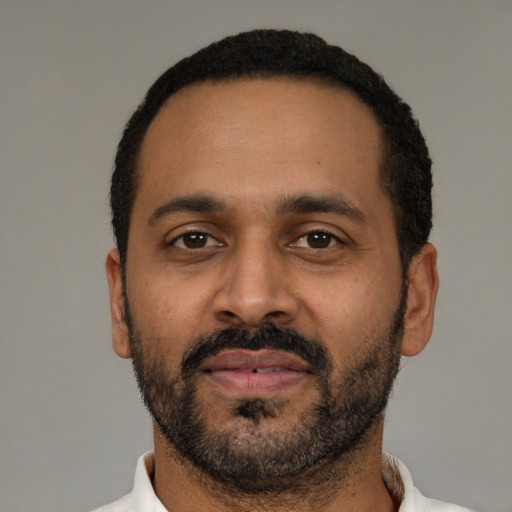 Neutral latino adult male with short  black hair and brown eyes