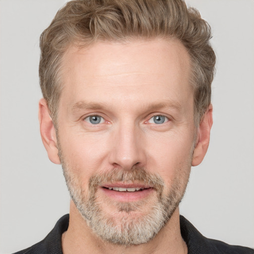 Joyful white adult male with short  brown hair and grey eyes