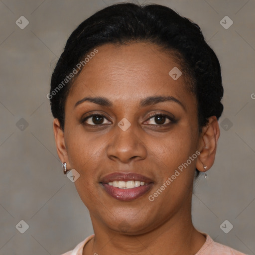 Joyful black adult female with short  brown hair and brown eyes