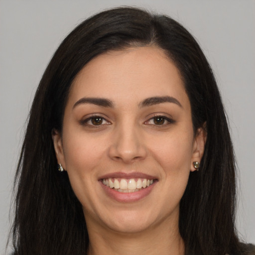 Joyful white young-adult female with long  brown hair and brown eyes