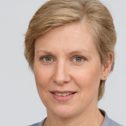 Joyful white adult female with medium  brown hair and grey eyes