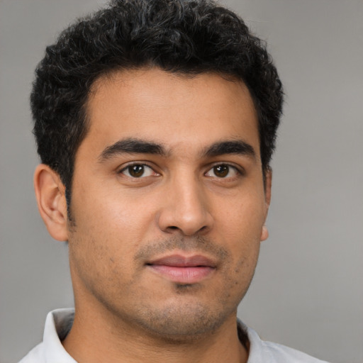 Neutral latino young-adult male with short  brown hair and brown eyes