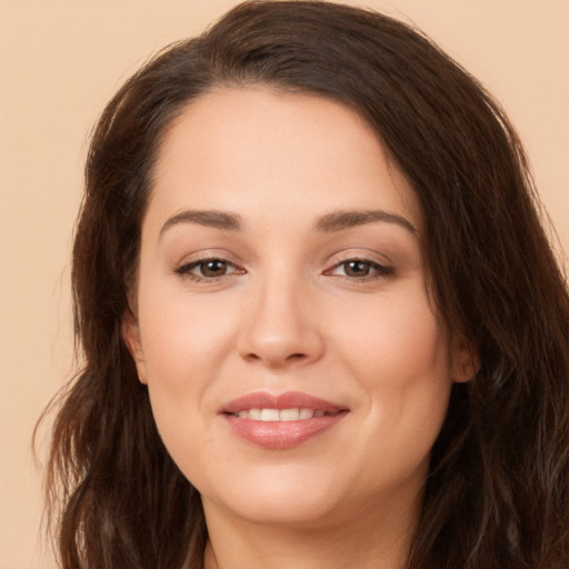 Joyful white young-adult female with long  brown hair and brown eyes