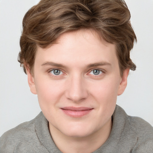 Joyful white young-adult female with short  brown hair and blue eyes