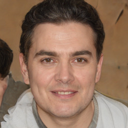 Joyful white adult male with short  brown hair and brown eyes