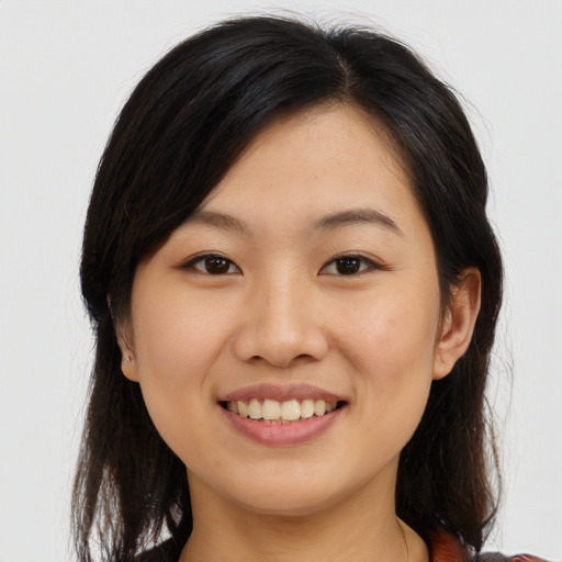 Joyful asian young-adult female with long  brown hair and brown eyes