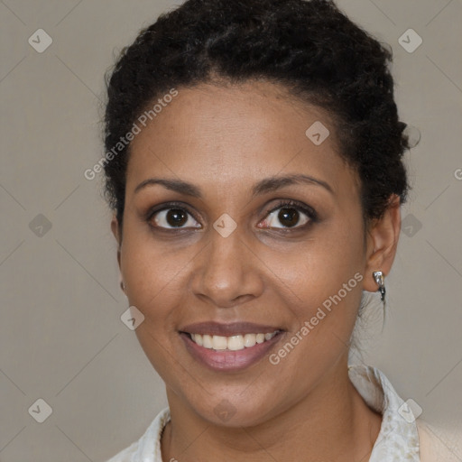 Joyful black young-adult female with short  brown hair and brown eyes