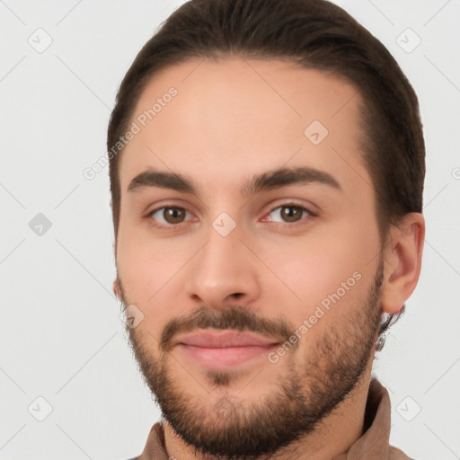 Joyful white young-adult male with short  brown hair and brown eyes