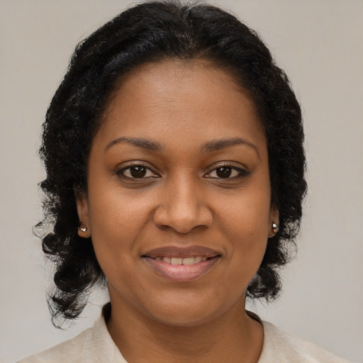 Joyful black young-adult female with medium  brown hair and brown eyes