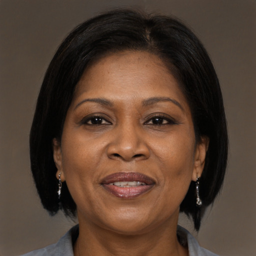 Joyful black adult female with medium  brown hair and brown eyes