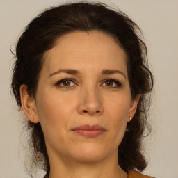 Joyful white young-adult female with medium  brown hair and green eyes