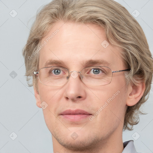 Joyful white adult male with short  brown hair and blue eyes