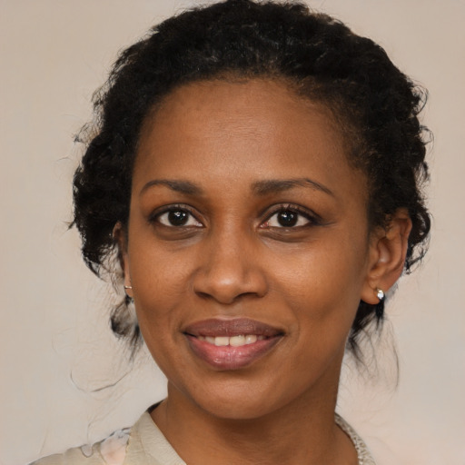Joyful black young-adult female with medium  black hair and brown eyes